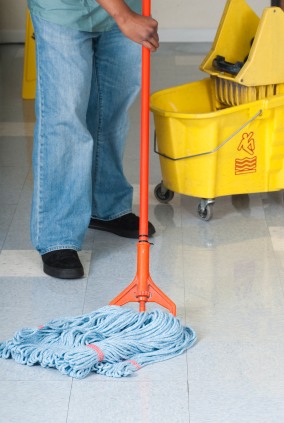 Vamp Building Maintenance of Columbia janitor in Columbia, SC mopping floor.